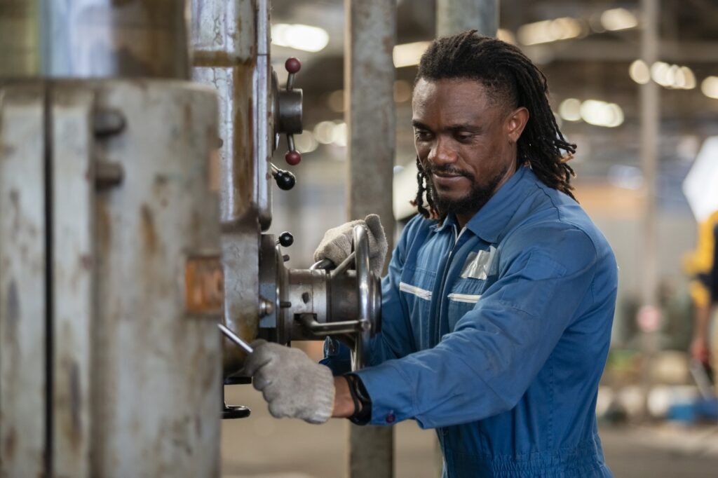 Engineering man wearing uniform safety workers perform maintenance in factory